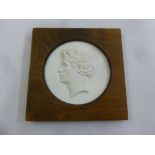 A Meissen framed circular plaque mounted in a wooden frame of a man in profile, produced for the