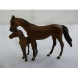 A cold painted bronze figurine of a horse with her foal