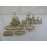 A French glass and gilded metal dressing table set comprising four glass jars, a carafe on stand