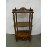 A mahogany three tier etagere of rectangular form with barley twist supports