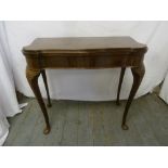 An Edwardian mahogany games table, rectangular on cabriole legs