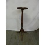 A mahogany pedestal plant stand on tripod base