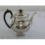 A George III silver coffee pot of fluted baluster form with gadrooned borders, raised hinged cover