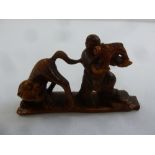 A Chinese carved deer horn figurine of a man and a tiger