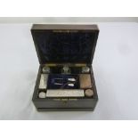 A Victorian coromandel vanity case with silver plated fittings, bottles, and a manicure set