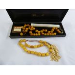 A set of Amber worry beads and another set worry beads to include certificate