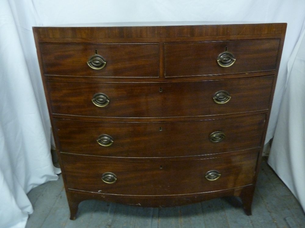 A Victorian mahogany bow fronted chest of drawers with brass handles and bracket feet