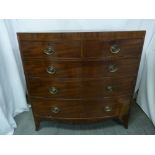 A Victorian mahogany bow fronted chest of drawers with brass handles and bracket feet