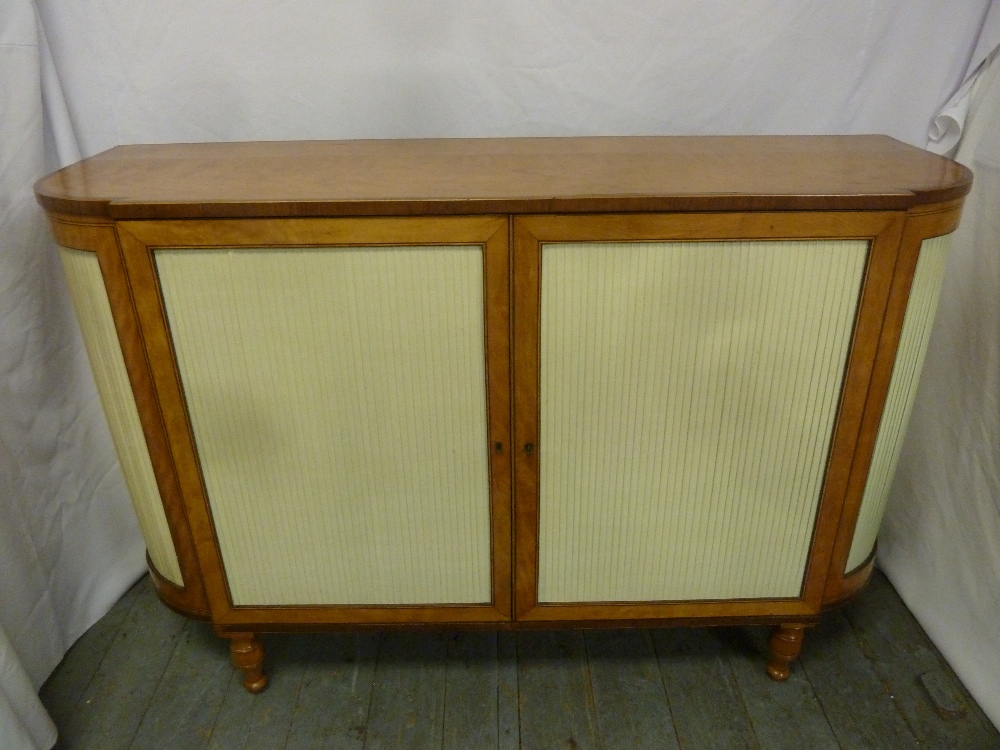 A late George III satinwood and rosewood D shaped side cabinet with hinged doors on four turned