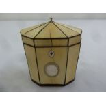 A George III ivory octagonal tea caddy with applied silver cartouche, escutcheon and finial to