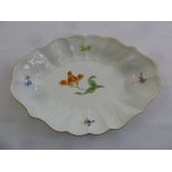A Meissen shaped oval dish decorated with flowers and gilded edges, marks to the base