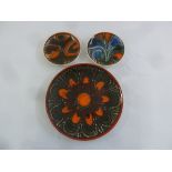 Three Poole Pottery decorative plates, marks to the base