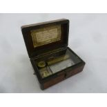 A French 19th century ebonised wooden music box with hinged cover