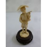 An early 20th century Japanese ivory figurine of a gentleman on carved circular base with