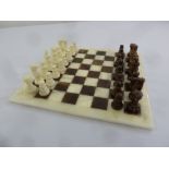 An Italian marble chess set and chess board made by Chiellini