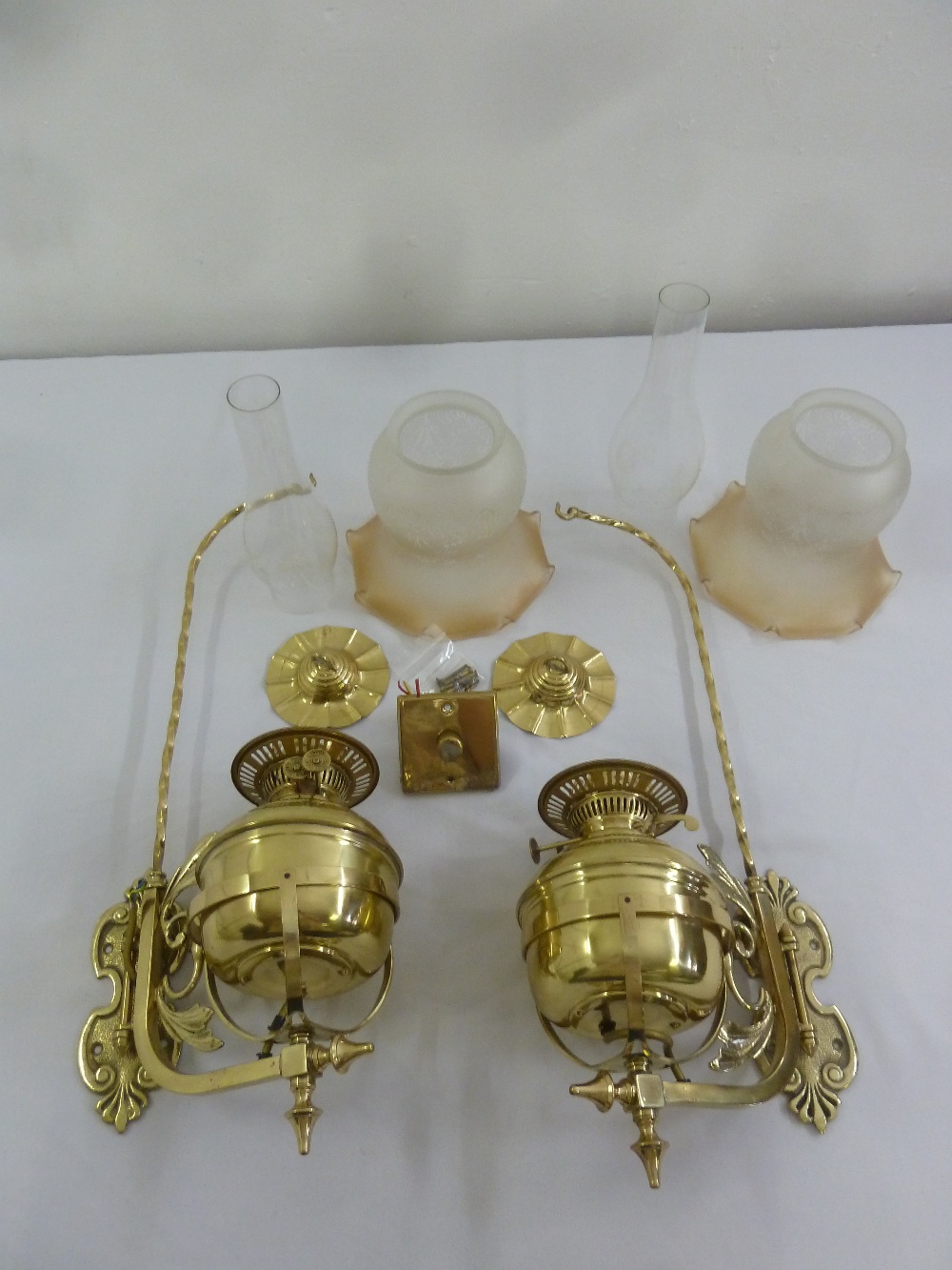 A pair of Victorian style brass wall lights converted to electric