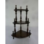 A mahogany three tier wall mounted whatnot with turned baluster supports