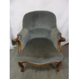 A Victorian upholstered mahogany occasional chair on cabriole legs and castors