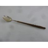 A mid 18th century silver straining spoon with part pierced bowl and turned wooden handle