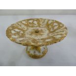A Meissen 19th century cake stand decorated with gilded flowers, scrolls and feathers, marks to