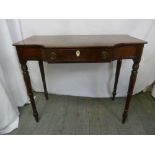 A Victorian mahogany shaped rectangular dressing table with single drawer on four turned tapering