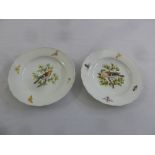 A pair of Meissen early 19th century plates decorated with birds and flowers and gilded borders,
