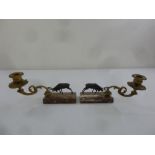 A pair of bronze candle holders supported by stags on rectangular marble bases, circa 1900