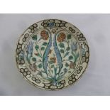 An early Iznick circular dish with stylised floral decoration, A/F