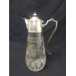 A cut glass and silver plated claret jug with scroll handle and domed hinged cover