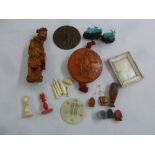 A quantity of collectables to include a jade pendant, a wax seal, a carved wooden Oriental