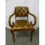 A mahogany armchair with leather seat and back on cabriole legs