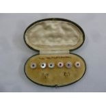 A cased set of six silver gilt and Mother of Pearl dress buttons