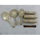 A quantity of silver mounted dressing table pieces to include a hand mirror, a hair brush, clothes