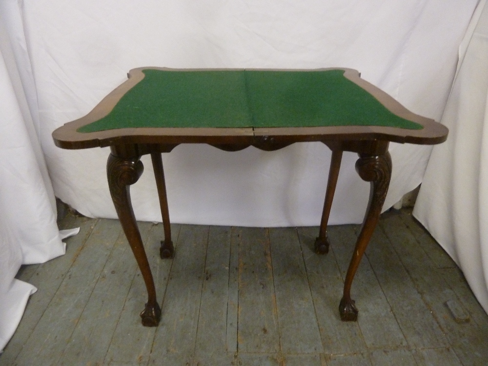 An early 20th century mahogany games table on four cabriole legs with ball and claw feet - Image 2 of 2