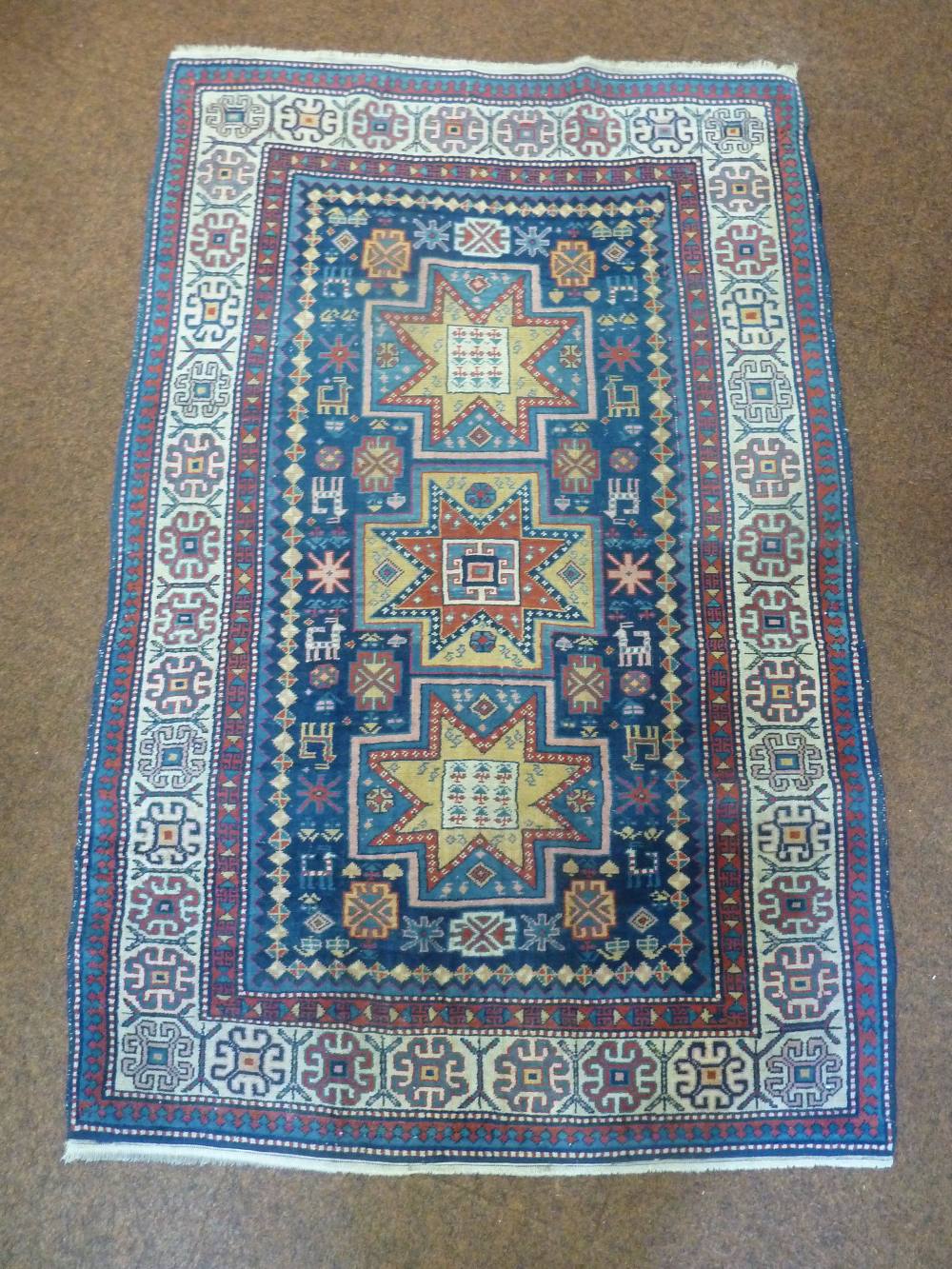 A Middle Eastern wool carpet, blue ground with repeating pattern and border, 184 x 120cm