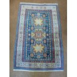 A Middle Eastern wool carpet, blue ground with repeating pattern and border, 184 x 120cm