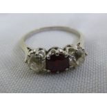 A platinum, ruby and diamond three stone ring, approx total weight 3.4g