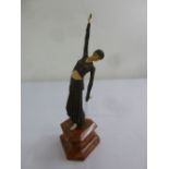 An Art Deco figurine of a dancing girl on triform marble base