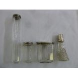 Four faceted glass dressing table bottles with silver covers