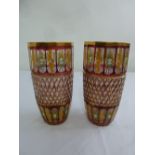 A pair of early 20th century Bohemian red and yellow over painted cut glass vases