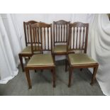 A set of four mahogany dining chairs with upholstered seats