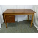 A Danish 1960 Teak desk with three drawers and drop flap side table on tapering tubular legs