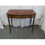 An Edwardian rectangular desk with tooled leather top on tapering fluted legs and single drawer