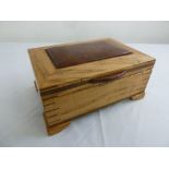 A rectangular yew wood agar humidor with hinged cover and three compartments on four bracket feet