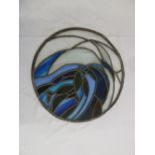 A circular stained glass window panel of abstract form, 50cm diameter