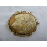 A Victorian cameo, carved with classical figures and a bird within a scroll pierced gilt metal