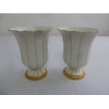 A pair of Meissen scalloped edge vases with gilded decorations on raised circular bases