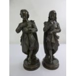 A pair of bronze figurines of 19th century scholars on raised circular plinths, 44cm (h)