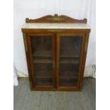 A rectangular glazed mahogany display case with applied gilded metal mounts and marble top