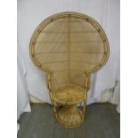 Wicker high back peacock chair of customary form